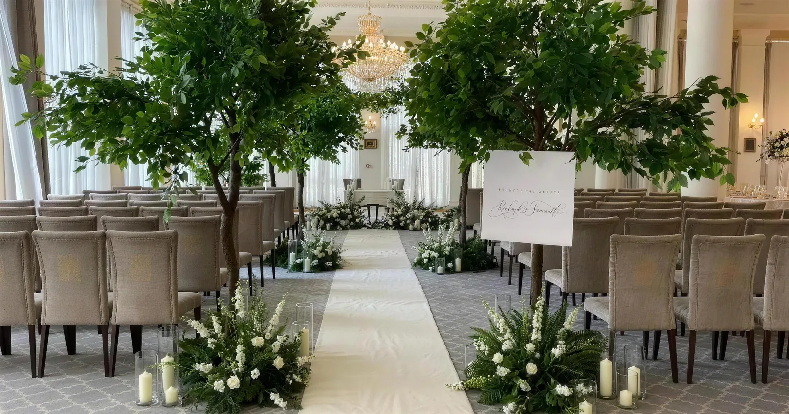 An undecorated ceremony room with grey chairs and a plain aisle